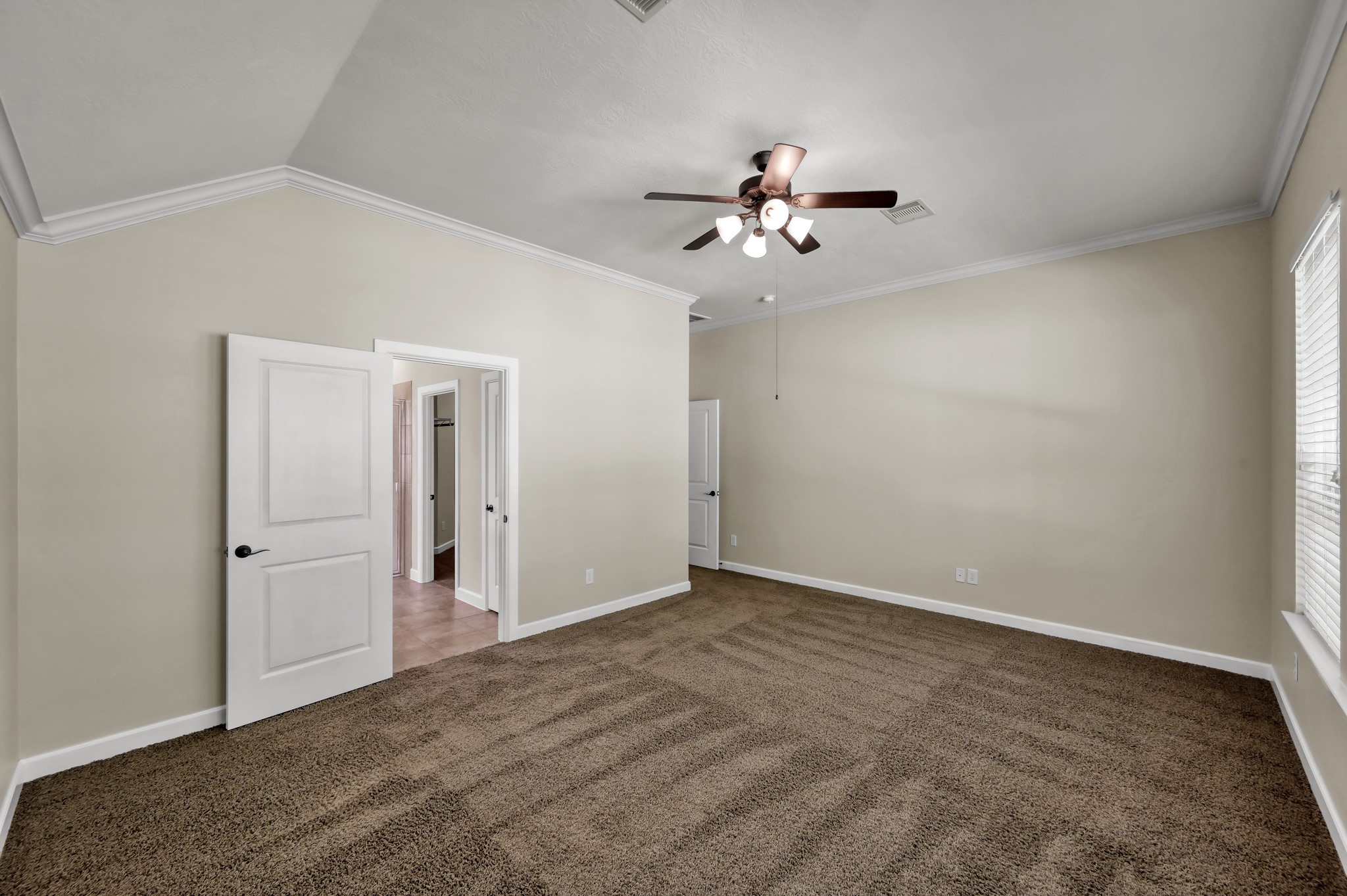 31507 Boulder Cliff Lane Spring, TX 77386 - Photo 37 of 45 This room features neutral walls, a ceiling fan, and carpeted flooring. It has ample natural light from a large window and includes a closet and an open door leading to an adjacent area.