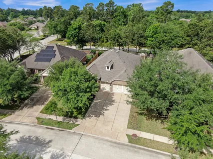 an aerial view of a house with a yard