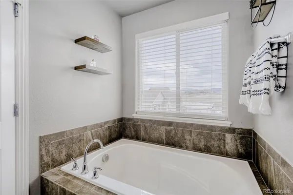 a bathroom with a bathtub and a window