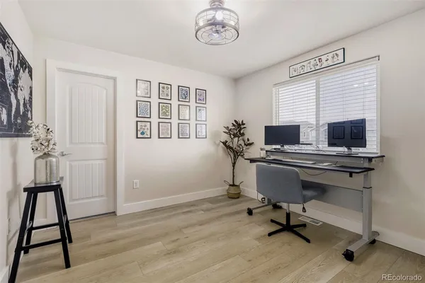 a view of a workspace with furniture and a window