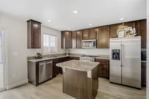 a kitchen with a refrigerator stove and sink