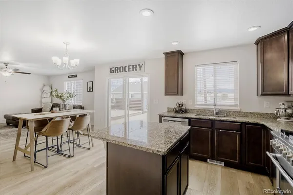 a kitchen with granite countertop a sink stove and cabinets