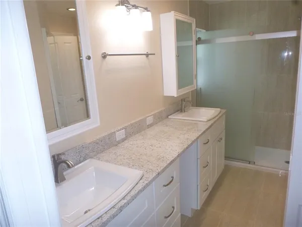 a bathroom with a shower and a sink