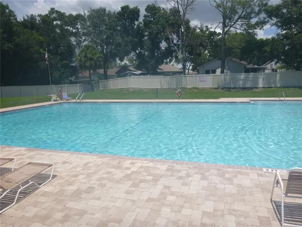 a view of a backyard with swimming pool