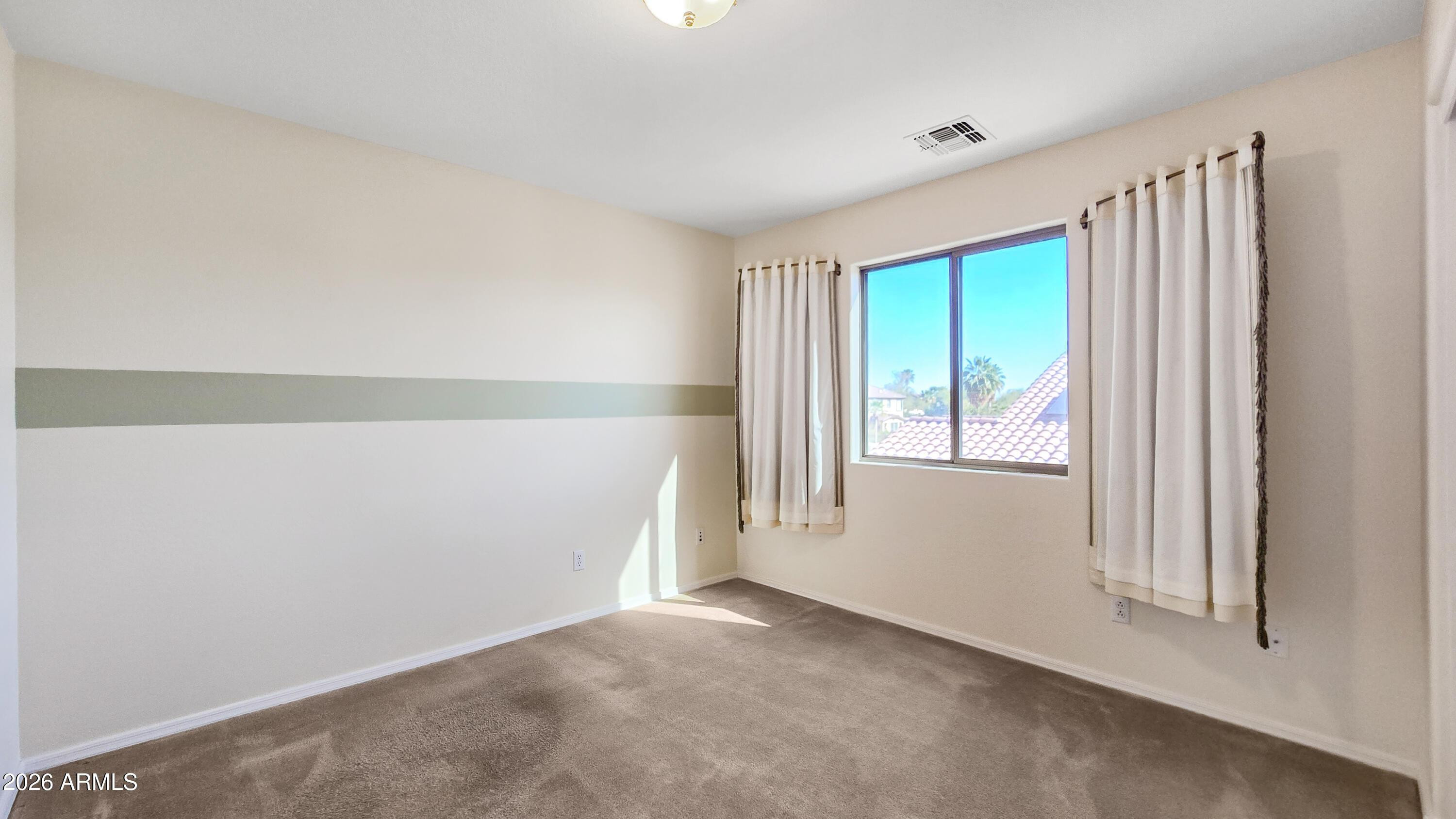 14226 West Wethersfield Road Surprise, AZ 85379 - Photo 44 of 50 a view of an empty room with a window