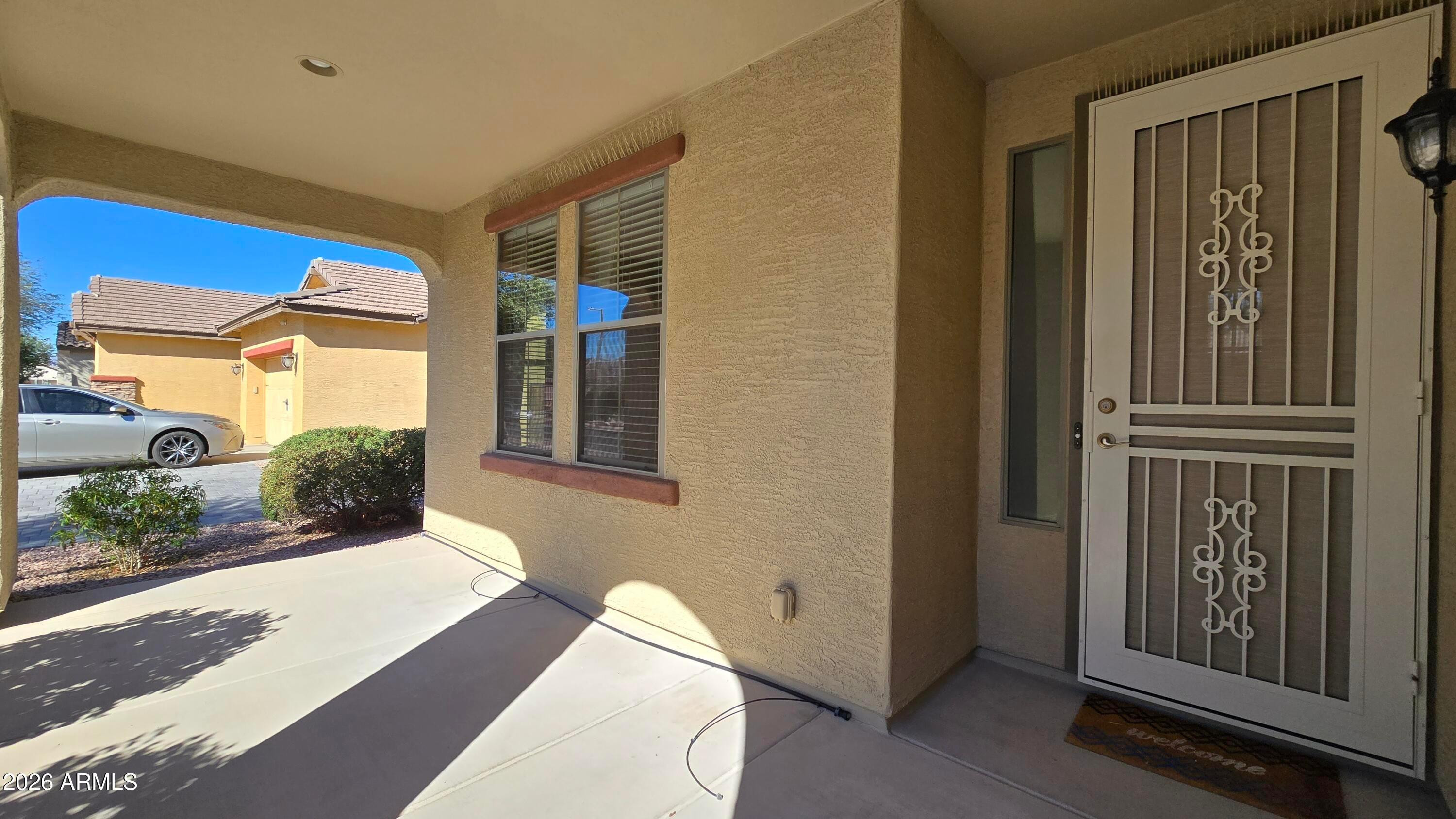 14226 West Wethersfield Road Surprise, AZ 85379 - Photo 5 of 50 a front view of a house with a porch