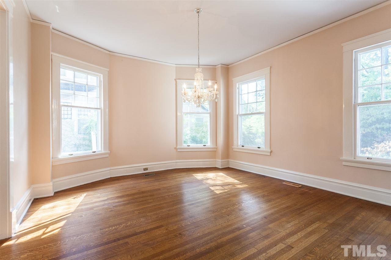 117 Forest Road Raleigh, NC 27605 - Photo 7 of 30 One Wall of the Dining Room is a Wide Bay Window. Crystal Chandelier and Hardwood Floors.