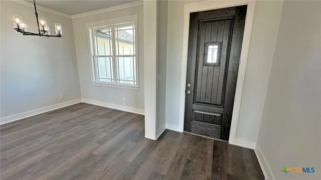 a kitchen with granite countertop a stove a sink and a refrigerator