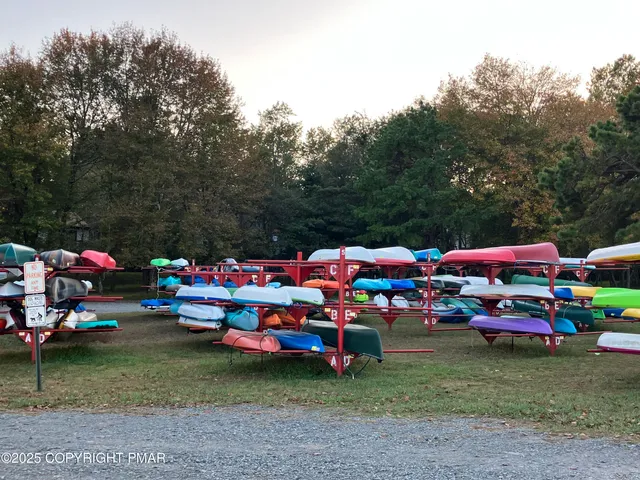 a kitchen with granite countertop a refrigerator stove top oven and sink