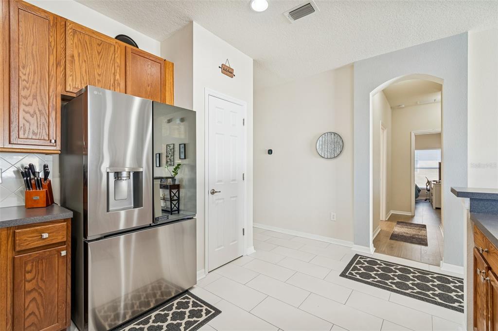 5956 Desert Peace Avenue Land O' Lakes, FL 34639 - Photo 15 of 79 a kitchen with stainless steel appliances granite countertop a refrigerator and a stove top oven