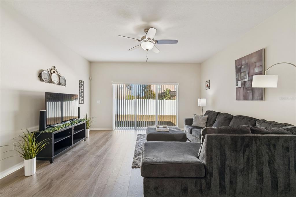 5956 Desert Peace Avenue Land O' Lakes, FL 34639 - Photo 25 of 79 a living room with furniture fireplace and flat screen tv