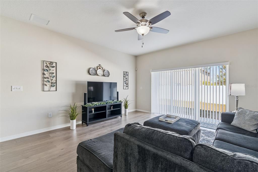 5956 Desert Peace Avenue Land O' Lakes, FL 34639 - Photo 26 of 79 a living room with furniture and a flat screen tv