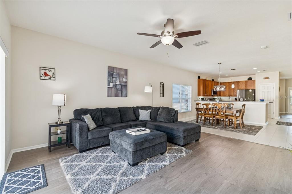 5956 Desert Peace Avenue Land O' Lakes, FL 34639 - Photo 29 of 79 a living room with furniture and kitchen view