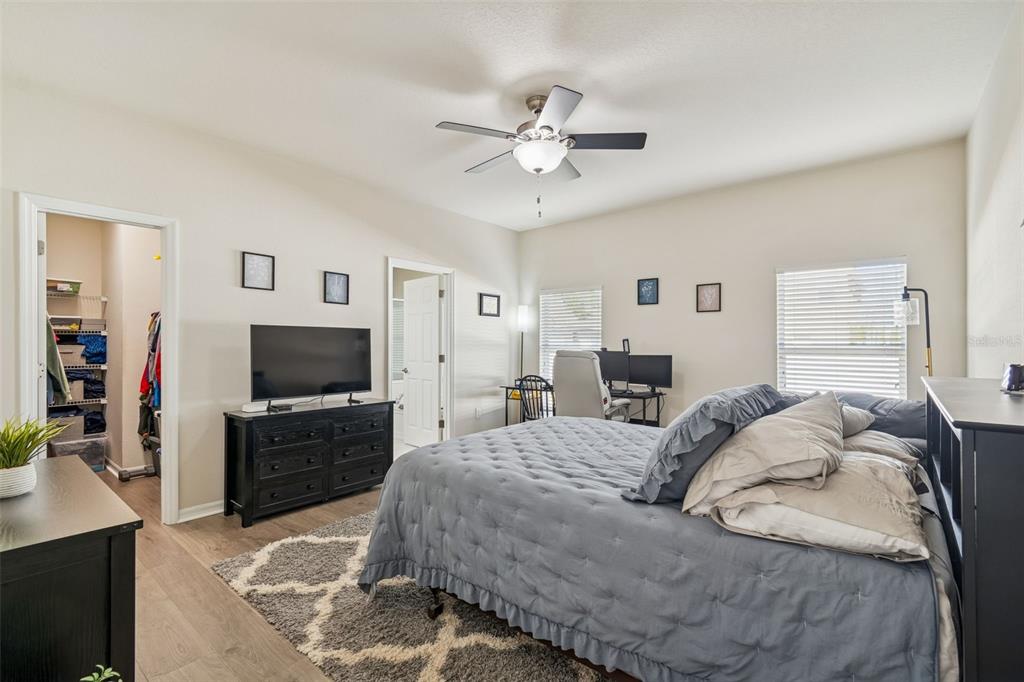 5956 Desert Peace Avenue Land O' Lakes, FL 34639 - Photo 30 of 79 a bedroom with a bed and a flat screen tv