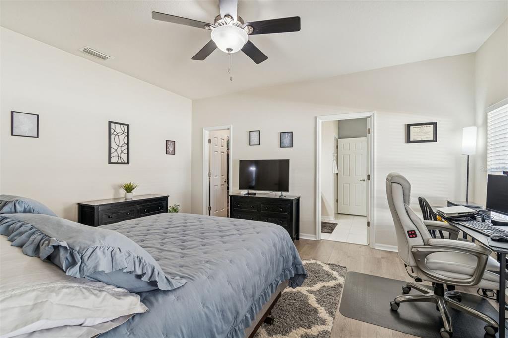 5956 Desert Peace Avenue Land O' Lakes, FL 34639 - Photo 33 of 79 a bedroom with a bed and a flat screen tv