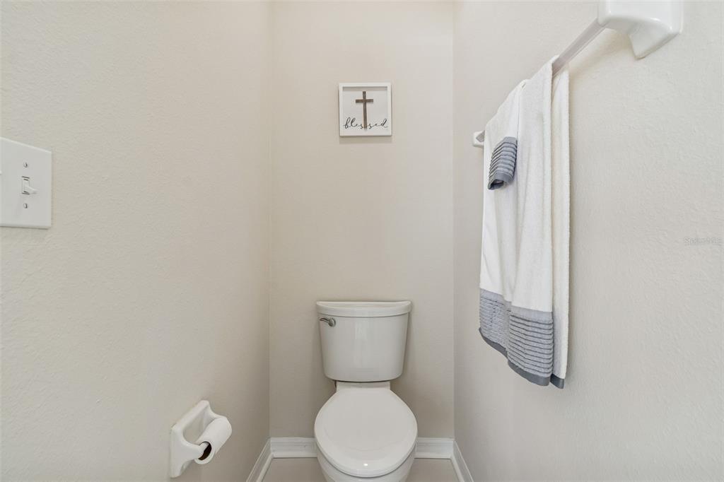 5956 Desert Peace Avenue Land O' Lakes, FL 34639 - Photo 38 of 79 a white toilet sitting next to a white wall