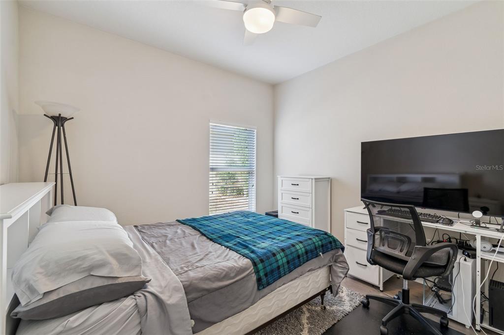 5956 Desert Peace Avenue Land O' Lakes, FL 34639 - Photo 45 of 79 a bedroom with a bed and a flat screen tv