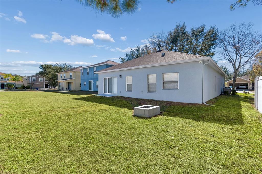 5956 Desert Peace Avenue Land O' Lakes, FL 34639 - Photo 50 of 79 a view of a house with a yard and sitting area