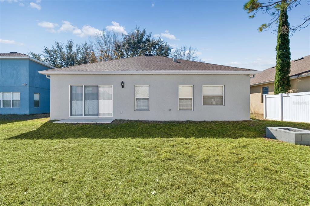 5956 Desert Peace Avenue Land O' Lakes, FL 34639 - Photo 51 of 79 a view of a house with a yard