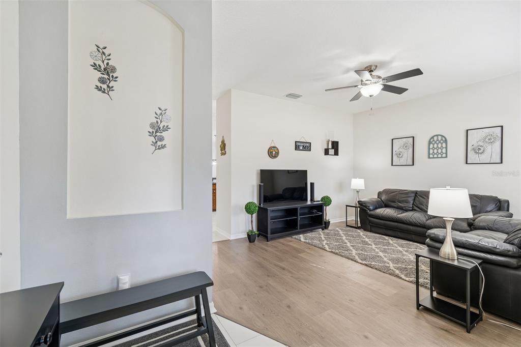 5956 Desert Peace Avenue Land O' Lakes, FL 34639 - Photo 7 of 79 a living room with furniture and a flat screen tv