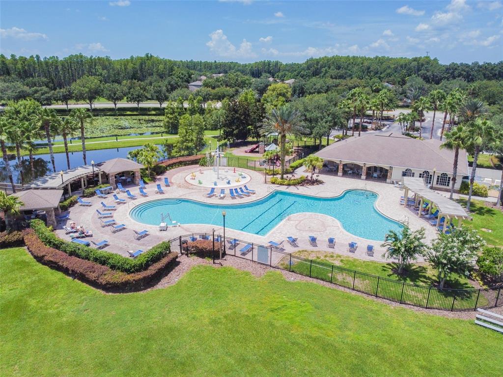 5956 Desert Peace Avenue Land O' Lakes, FL 34639 - Photo 73 of 79 an aerial view of a house with garden space and outdoor seating