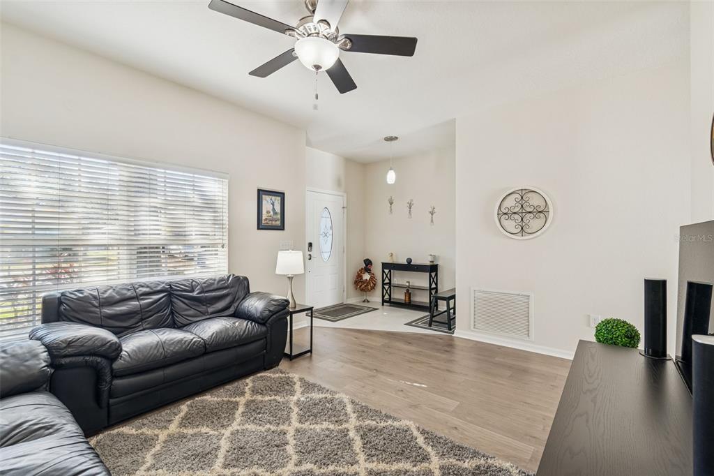 5956 Desert Peace Avenue Land O' Lakes, FL 34639 - Photo 10 of 79 a living room with furniture and a large window