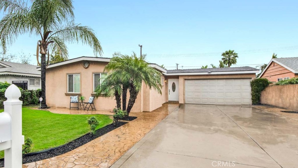 2210 West 9th Street Santa Ana, CA 92703 - Photo 1 of 1 a front view of a house with a yard and garage