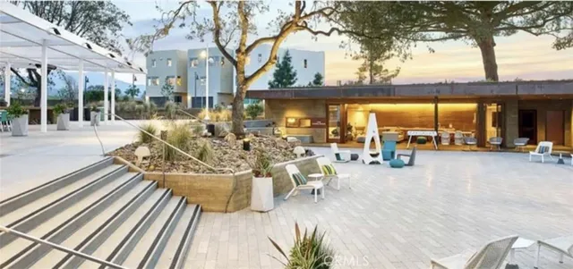 a view of a chairs and table in patio with a yard