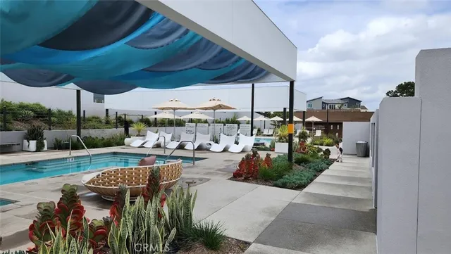 a living room with patio furniture and a potted plant