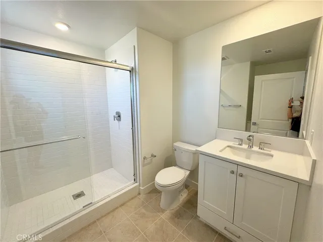 a kitchen with kitchen island white cabinets and stainless steel appliances