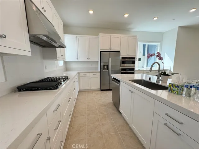 a kitchen with stainless steel appliances a refrigerator and a stove