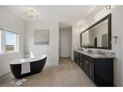 a spacious bathroom with a double vanity sink and a mirror