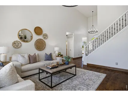 a living room with couches chair and a large window
