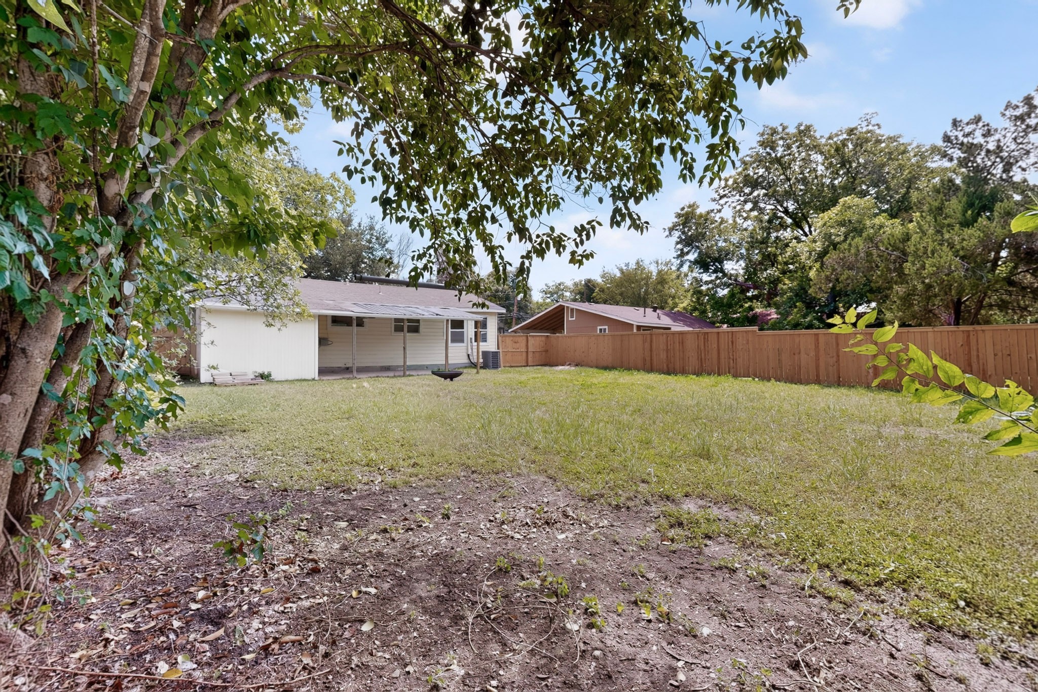 4711 Alf Avenue Austin, TX 78721 - Photo 31 of 34 A spacious backyard with a private fence and natural shade from mature trees.