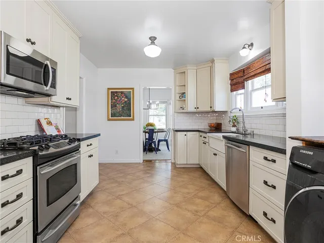 a kitchen with stainless steel appliances granite countertop a stove and a sink