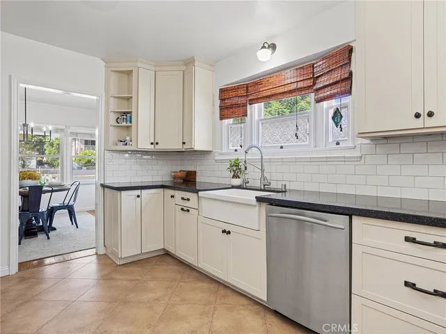 a kitchen with granite countertop white cabinets and white appliances