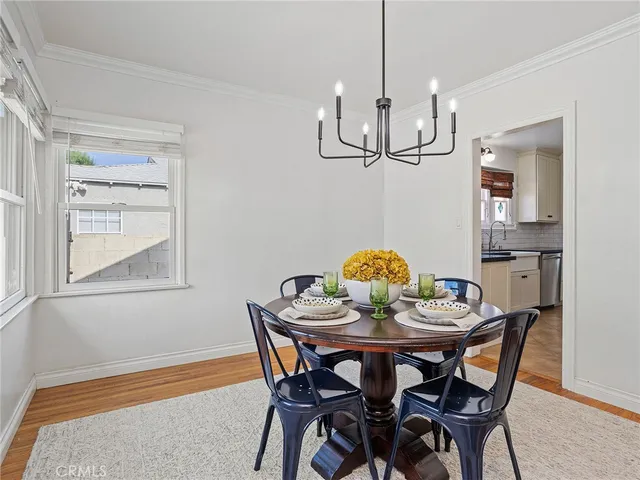 a view of a dining room with a table and chairs