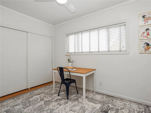 a view of a room with a table and chairs