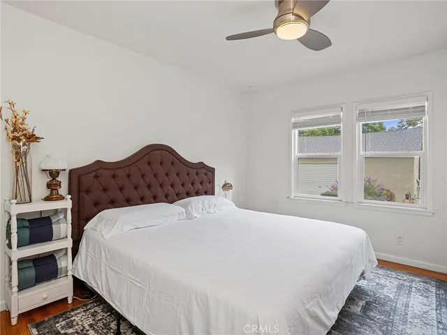 a large bed sitting in a bedroom next to a window