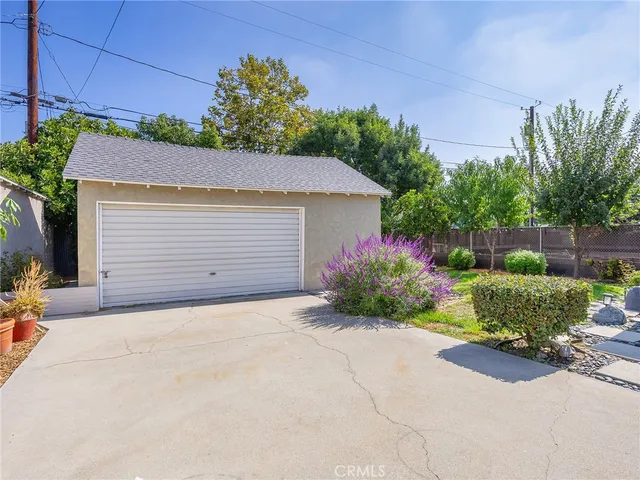 a front view of a house with a yard and a garage