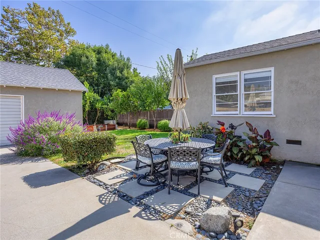 a view of a patio with table and chairs and wooden floor