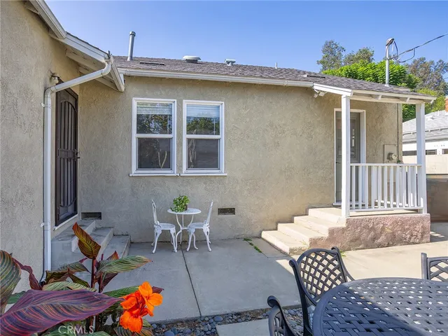 a front view of a house with a garden and yard