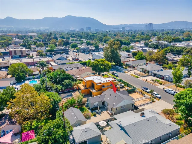 an aerial view of a houses with a swimming pool