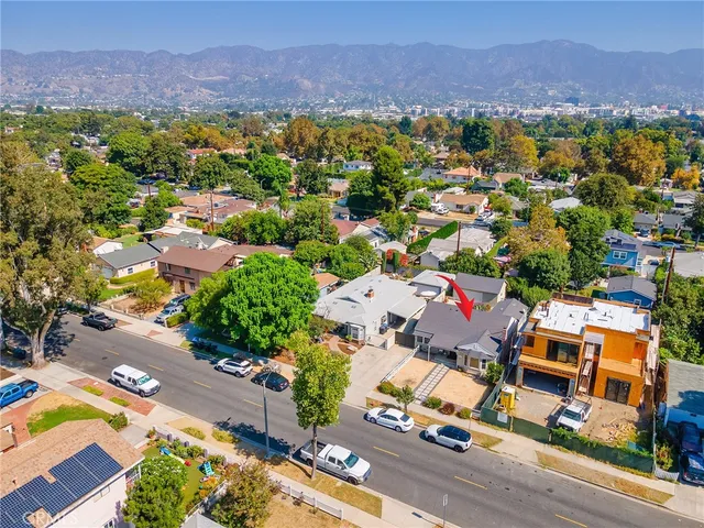 an aerial view of a house with a yard
