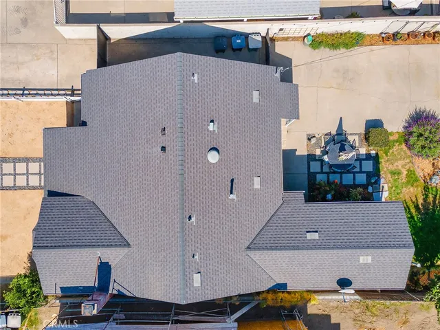 an aerial view of a house with yard and garage