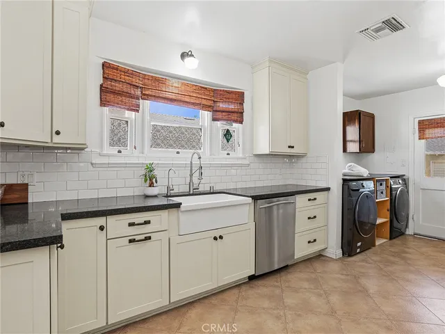 a kitchen with granite countertop white cabinets and white appliances