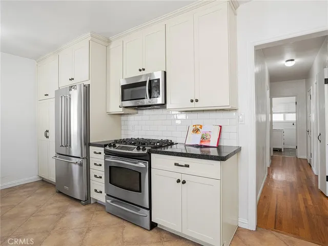 a kitchen with stainless steel appliances granite countertop a stove and a refrigerator