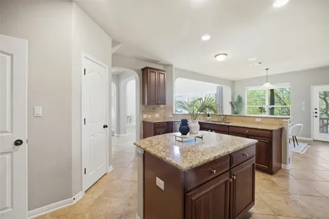 a living room with granite countertop furniture and fireplace