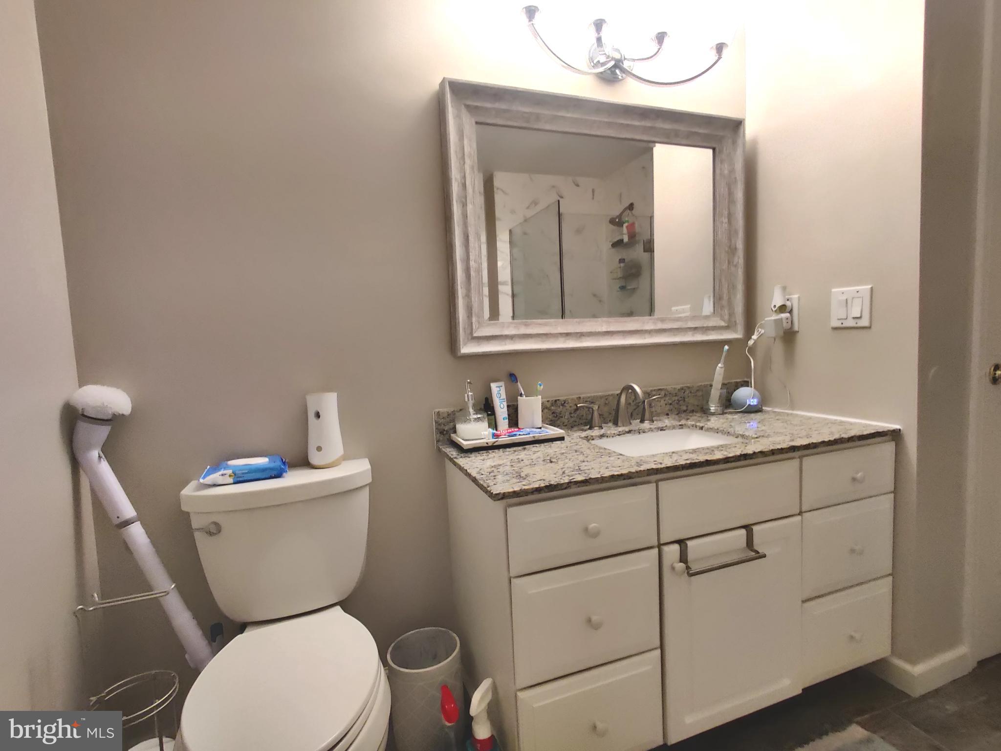 23 Stokes Road Mount Laurel, NJ 08054 - Photo 11 of 18 a bathroom with a toilet sink and mirror