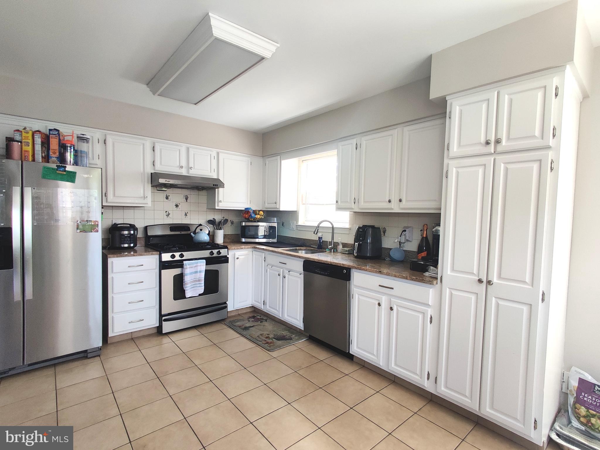 23 Stokes Road Mount Laurel, NJ 08054 - Photo 7 of 18 a kitchen with white cabinets stainless steel appliances and sink